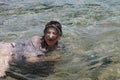 Woman photographer diving into water of Red sea