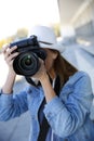 Woman photographer holding reflex camera Royalty Free Stock Photo