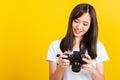 Woman photographer holding vintage digital mirrorless photo camera on hands Royalty Free Stock Photo