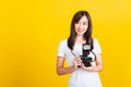 Woman photographer holding vintage digital mirrorless photo camera on hands Royalty Free Stock Photo