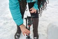 Woman photographer lays out a Monfroto tripod on the snow. Russia, Tatarstan, March 03, 2019