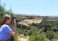 Woman photographer Nature photographer shooting in the mountains. Travel Concept Royalty Free Stock Photo