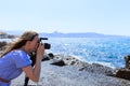 Woman photographer Nature photographer shooting the sea. Travel Concept