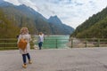 Woman photographer portraying a girl with a beautiful lake in the background Royalty Free Stock Photo