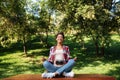 Woman photographer sitting outdoors in park meditate Royalty Free Stock Photo