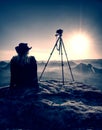 Woman photographer take a rest after taking picture of landscape