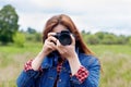 Woman photographer takes pictures with a camera