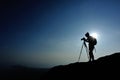 Woman photographer taking photos at mountain peak Royalty Free Stock Photo