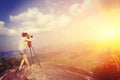 Woman photographer taking photos at mountain peak Royalty Free Stock Photo