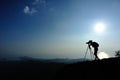 Woman photographer taking photos at mountain peak Royalty Free Stock Photo