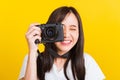 Woman photographer taking picture and looking viewfinder on digital mirrorless photo camera Royalty Free Stock Photo