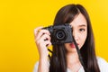 Woman photographer taking picture and looking viewfinder on digital mirrorless photo camera Royalty Free Stock Photo