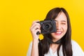 Woman photographer taking picture and looking viewfinder on digital mirrorless photo camera Royalty Free Stock Photo
