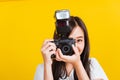 Woman photographer taking picture and looking viewfinder on digital mirrorless photo camera Royalty Free Stock Photo