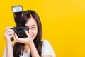 Woman photographer taking picture and looking viewfinder on digital mirrorless photo camera Royalty Free Stock Photo