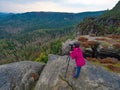 Woman photographer is taking pictures with camera in morning hills