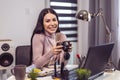 Woman photographer working with laptop at the working place with computers Royalty Free Stock Photo