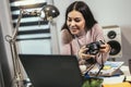 Woman photographer working with laptop at the working place with computers in the studio Royalty Free Stock Photo