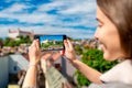 Woman photographing Bratislava cityscape