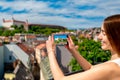 Woman photographing Bratislava cityscape