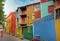 Woman photographing a child in front of colorful buildings of the Argentinean district La Boca, in Buenos Aires, during