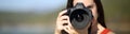 Woman photographing with dslr camera looking at you Royalty Free Stock Photo