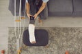 Woman photographing her leg in a plaster cast for an online consultation with a doctor. Royalty Free Stock Photo