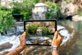 Woman photographing house on Buna spring in Blagaj Royalty Free Stock Photo