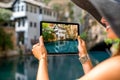 Woman photographing house on Buna spring in Blagaj Royalty Free Stock Photo