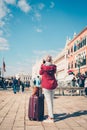 Woman photographing sights of Venice.