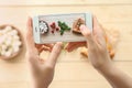 Woman photographing slice of delicious pizza Margherita with mobile phone