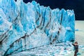 Woman photographs the blue ice wall
