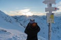 Woman photographs the sunrise on the Zawrat Pass in the Tatra Mountains in winter Royalty Free Stock Photo