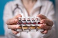 Woman physician holds out the stack of tablets in front of him. the concept of paid medicine