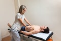 Woman physiotherapist does session to man. visceral ostropathy Royalty Free Stock Photo