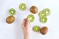 Woman pick up fresh green kiwi fruit slide front of flat lay background style