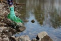 Woman picking up dump on dirty forest