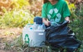 A woman picking up garbage plastic bottles into a box and plastic bag for recycling Royalty Free Stock Photo