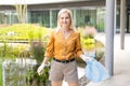 woman picking up plastic household waste in park Royalty Free Stock Photo