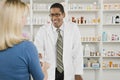 Woman Picking Up Prescription Drugs At Pharmacy Royalty Free Stock Photo