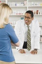 Woman picking up prescription drugs at pharmacy Royalty Free Stock Photo