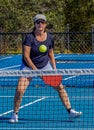 Woman pickleball player has her eye on the ball and paddle ready to hit a backhand dink Royalty Free Stock Photo