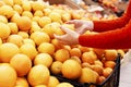 Woman picks juicy oranges in a supermarket. Healthy lifestyle and vitamins. Close-up Royalty Free Stock Photo