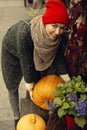 Woman picks a pumpkin for Halloween. Warm autumn colors