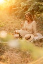 Woman picnic vineyard. Romantic dinner, fruit and wine. Happy woman with a glass of wine at a picnic in the vineyard on