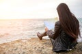 Woman on the pier watching map