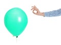 Woman piercing green balloon on white background