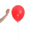 Woman piercing red balloon