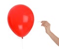 Woman piercing red balloon