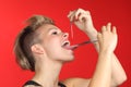 Woman piercing the tongue herself